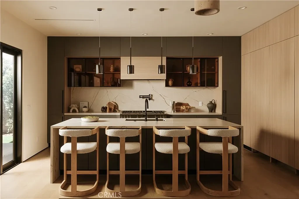 Wood cabinetry, open shelving, and a central island. — Casa Serena