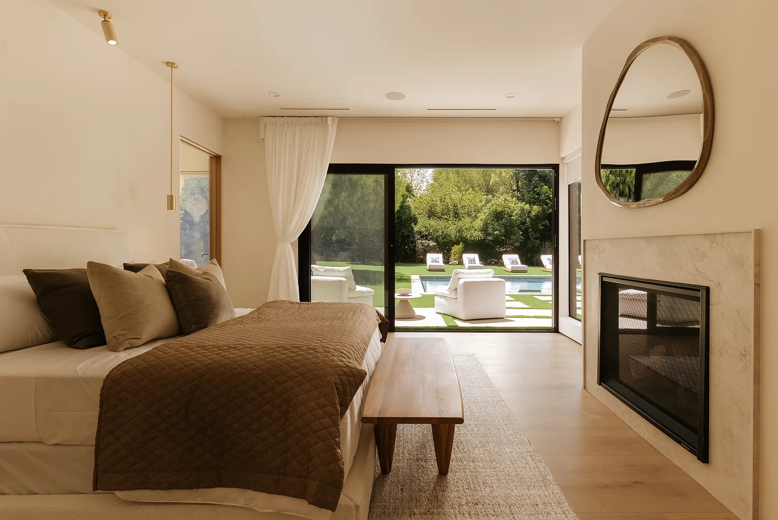 Light wood flooring beside the primary suite’s fireplace. — Casa Serena