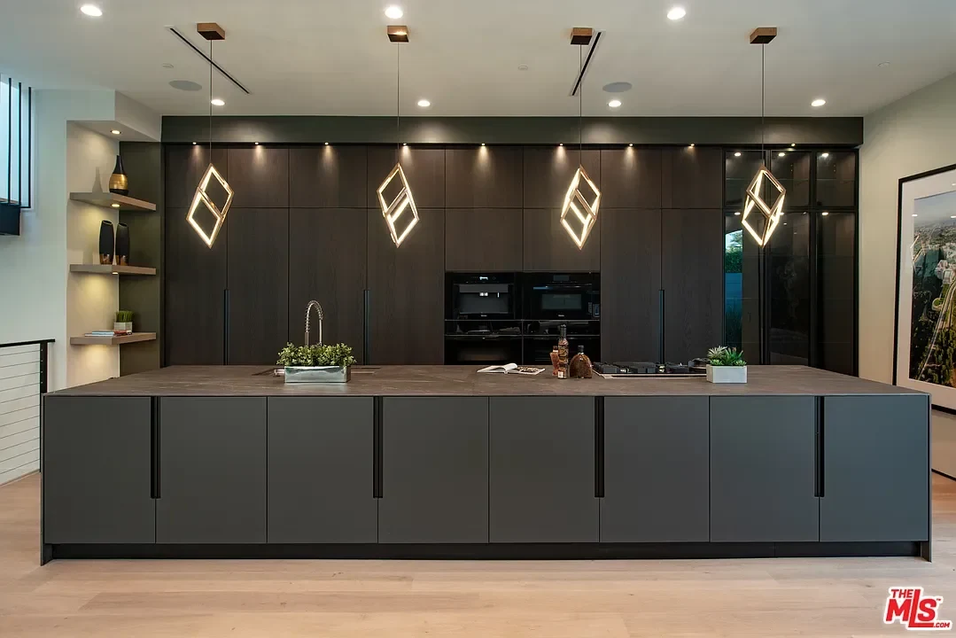 Wood flooring paired with a dark kitchen palette. — La Dulce Vida