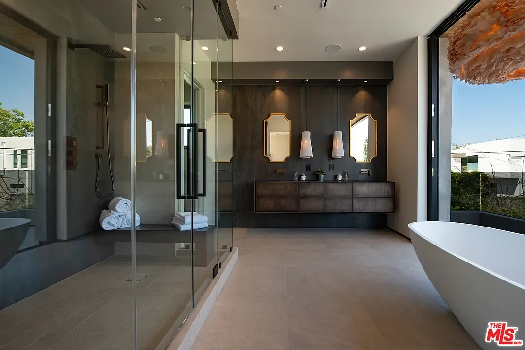 A tiled bathroom with a freestanding bath and double vanity. — La Dulce Vida